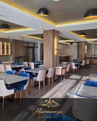 a restaurant with tables and chairs in a room at Harmonija Residence Hill 01 in Kopaonik