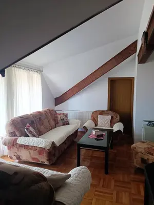 a living room with a couch and a table at Apartman Paunov Breg in Vrnjačka Banja