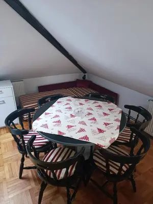 a table and chairs with a tablecloth on it at Apartman Paunov Breg in Vrnjačka Banja