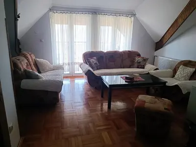 a living room with two couches and a coffee table at Apartman Paunov Breg in Vrnjačka Banja