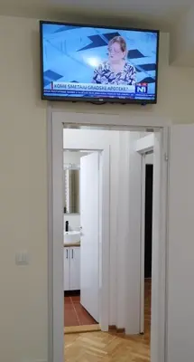 a flat screen tv on top of a white wall at Apartman Ognjen Vrnjacka Banja in Vrnjačka Banja