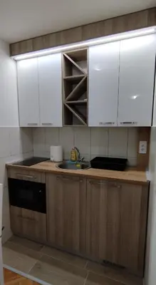 a kitchen with white cabinets and a sink at Apartman Ognjen Vrnjacka Banja in Vrnjačka Banja