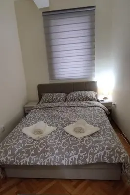 a bedroom with a bed with two towels on it at Apartman Ognjen Vrnjacka Banja in Vrnjačka Banja