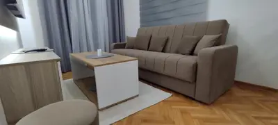 a living room with a couch and a table at Apartman Ognjen Vrnjacka Banja in Vrnjačka Banja