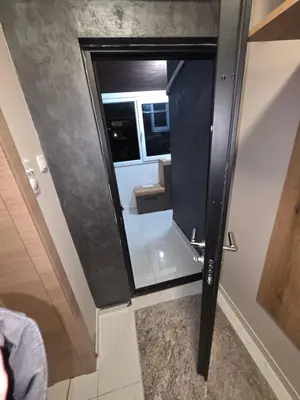 a glass door in a room with a mirror at Warm nest in Kraljevo