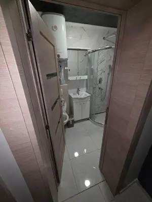 a small bathroom with a shower and a toilet at Warm nest in Kraljevo