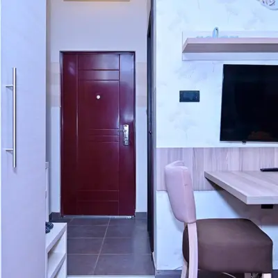 a door in a room with a chair and a table at K8 Milmari in Kopaonik