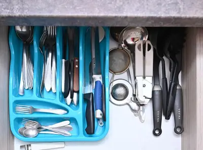 a blue tray filled with utensils in a drawer at K8 Milmari in Kopaonik