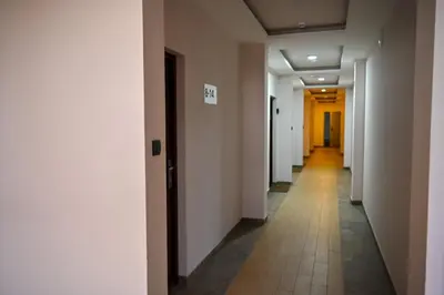 a hallway with white walls and a tile floor at K8 Milmari in Kopaonik