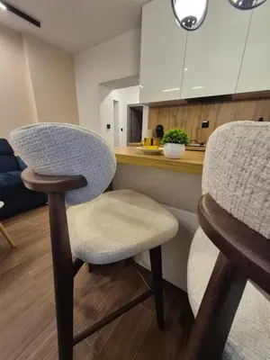 a kitchen with two chairs and a counter at Zira apartman in Vranje