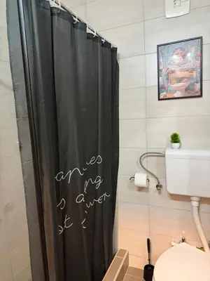 a bathroom with a shower curtain with the words are my forever at Zira apartman in Vranje