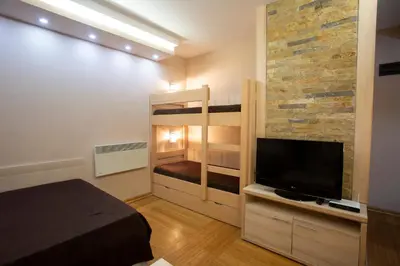 a bedroom with a bunk bed and a flat screen tv at Apartment HT in Kopaonik