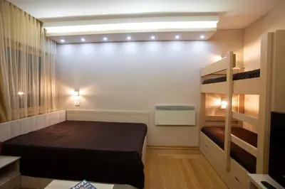 a small room with a bed and bunk beds at Apartment HT in Kopaonik