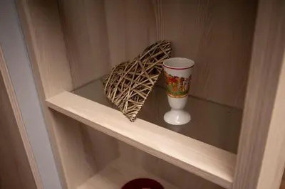 a wooden shelf with a cup and a heart on it at Apartment HT in Kopaonik