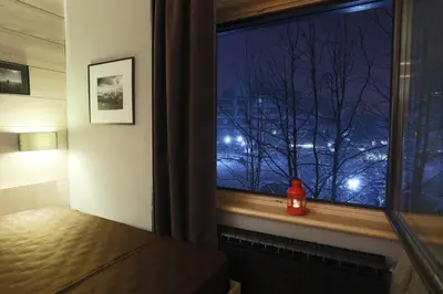 a window with a view of a city at night at Apartment HT in Kopaonik