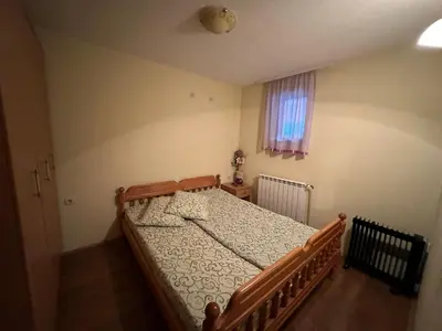 a bedroom with a large bed in a room at Urban Apartmens 5 in Jošanička Banja
