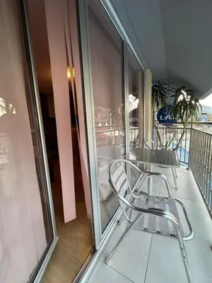 a balcony with a chair and a table on a balcony at Urban Apartmens 5 in Jošanička Banja