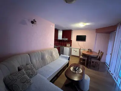 a living room with a couch and a table at Urban Apartmens 5 in Jošanička Banja