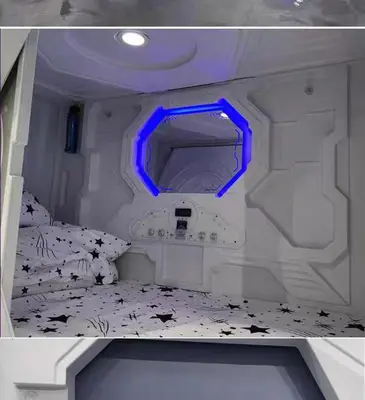 a small room with a bed with a blue light at Belgrade Airport Space Capsule Beds in Bukorovac