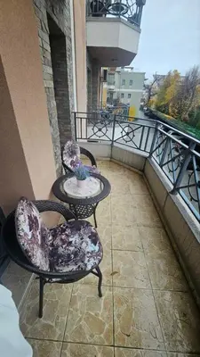 a balcony with two chairs and a table on a balcony at Vera Solaris in Vrnjci