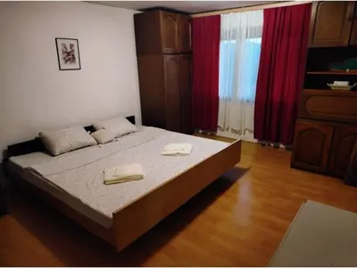 a bedroom with a bed with two towels on it at Apartman Poirot in Kuršumlija