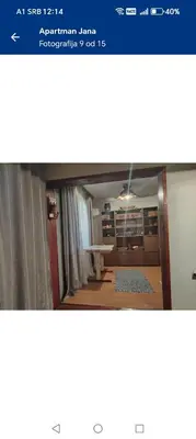 a view of a room with a window and a table at Apartman Poirot in Kuršumlija