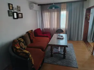 a living room with a couch and a table at Apartman Poirot in Kuršumlija