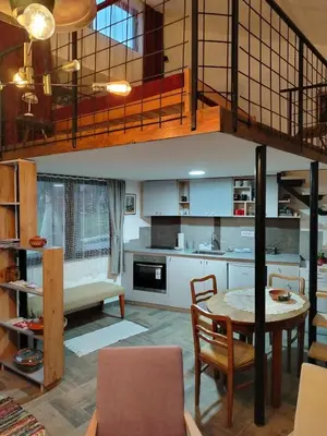 a kitchen and dining room with a loft at Apartman 