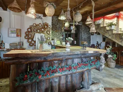 a bar in a room with christmas decorations on it at Srna Etno Selo - Hotel i Restoran in Inovo