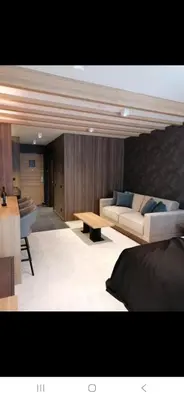 a living room with a couch and a table at Woodside 323 Kopaonik011 in Kopaonik