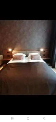 a bedroom with a large bed with two pillows at Woodside 323 Kopaonik011 in Kopaonik