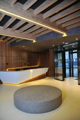 a lobby with a reception desk and a circular rug at Woodside 323 Kopaonik011 in Kopaonik