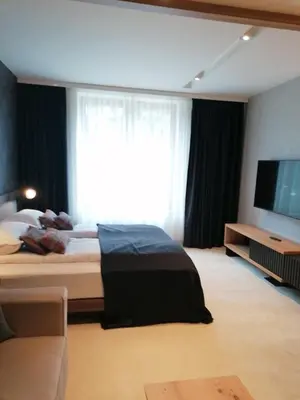 a bedroom with a bed and a large window at Woodside 323 Kopaonik011 in Kopaonik