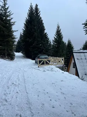 a car parked in the snow next to a house at Tara mountain house Kopaonik in Kopaonik