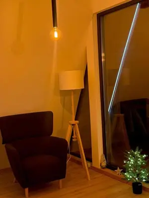 a living room with a chair and a lamp at Tara mountain house Kopaonik in Kopaonik