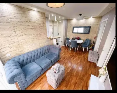 a living room with a blue couch and a table at Niš Central Stay in Niš