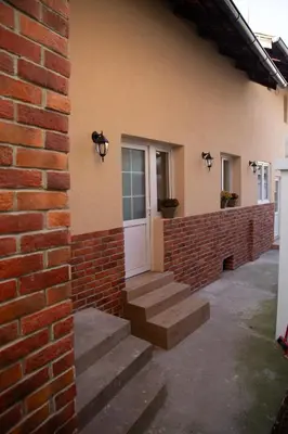 a brick building with stairs leading to a door at Urban Nest Apartments in Niš