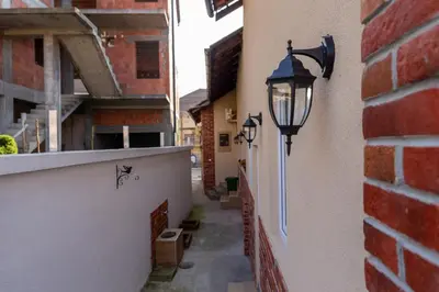 an alley with lights on the side of a building at Urban Nest Apartments in Niš