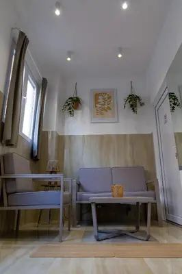 a living room with a purple couch and a table at Urban Nest Apartments in Niš