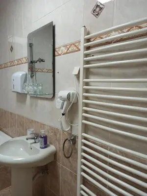 a bathroom with a sink and a mirror at Bella Notte apartments in Niš