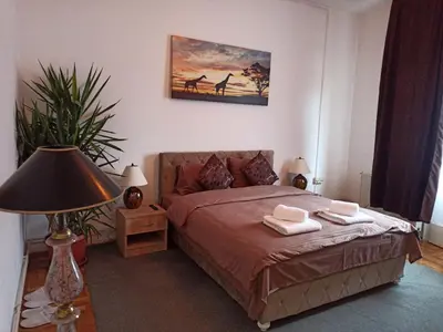 a bedroom with a bed with two towels on it at Bella Notte apartments in Niš