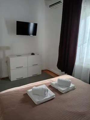 a bedroom with a bed with two towels on it at Bella Notte apartments in Niš