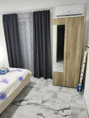 a bedroom with a bed and a mirror in it at Apartman Ristic Vrnjacka banja in Vrnjačka Banja