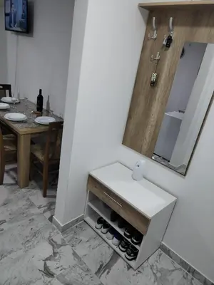 a bathroom with a sink with wine bottles in it at Apartman Ristic Vrnjacka banja in Vrnjačka Banja