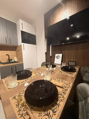 a kitchen with a table with black plates on it at Gohemi Apartments in Pirot