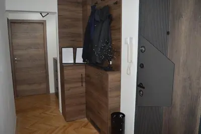 a door leading into a hallway with a wooden door sidx sidx sidx at Gohemi Apartments in Pirot