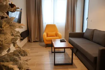 a living room with a couch and a chair at Apartmani Vidik,Treska in Kopaonik
