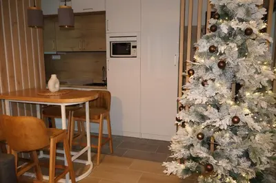 a white christmas tree in a kitchen with a table at Apartmani Vidik,Treska in Kopaonik