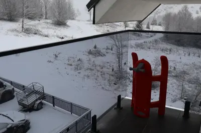 a view of a snow covered yard from a window at Apartmani Vidik,Treska in Kopaonik