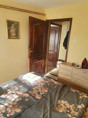 a bedroom with a bed with a dresser and a mirror at Mala Sirena in Bukorovac